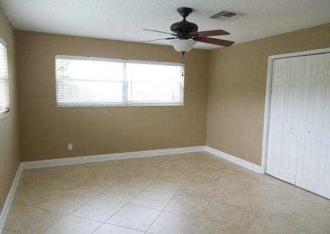 An empty room with newly painted walls and new tile flooring