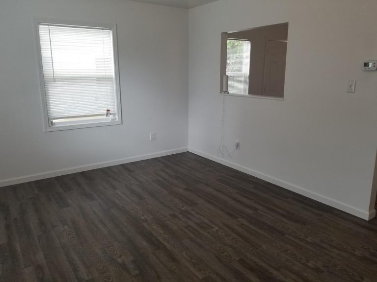A renovated living room installed with engineered hardwood flooring
