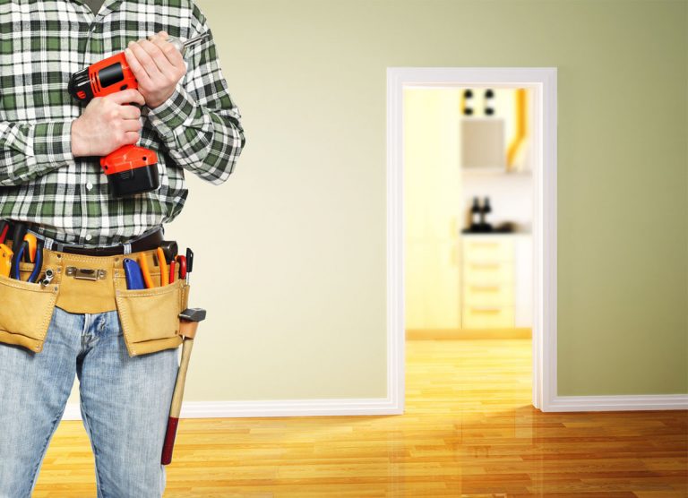 Home contractor carrying a portable drill