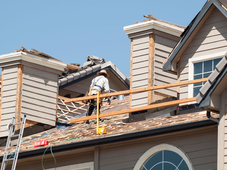 roofing contractors demolishing an asphalt roof