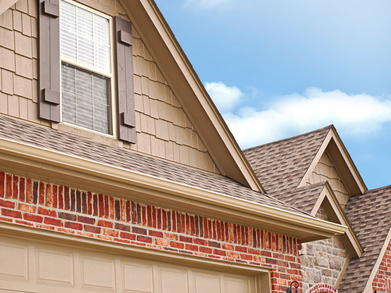 Brown painted house with brown asphalt shingle roofing