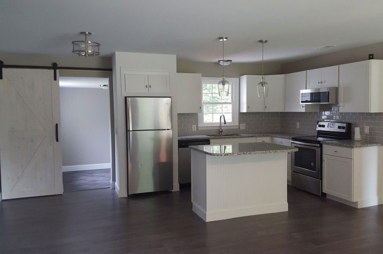 A newly refurbished kitchen equipped with granite countertops