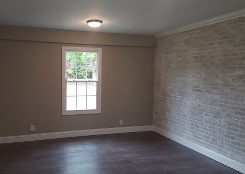 Renovated master bedroom painted with whitewash brick in Winston-Salem