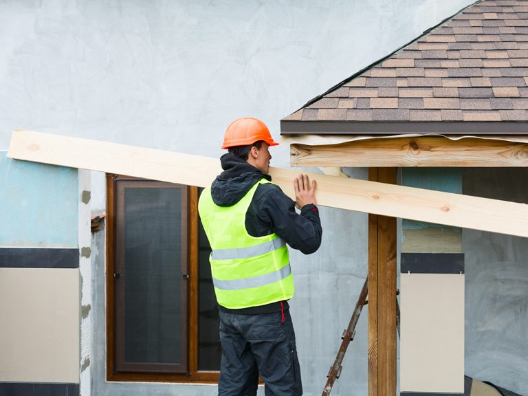 A carpenter remodeling a house