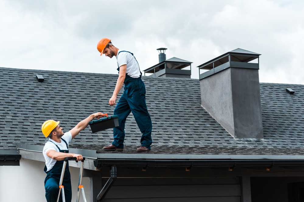 Home remodelers remodeling a house roof